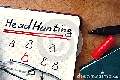 Notepad with Headhunting on office table. Stock Photo