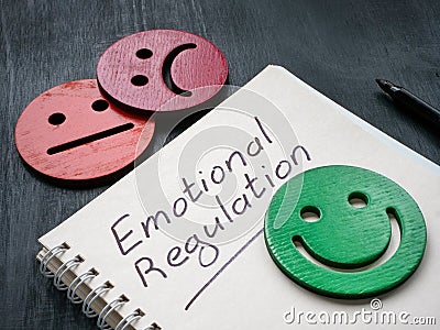Notepad with inscription emotional regulation and smiley. Stock Photo