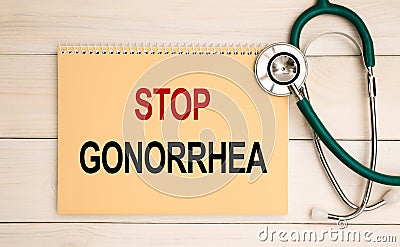 Notepad with the inscription Stop Gonorrhea and stethoscope Stock Photo