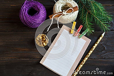 Notepad lays on the wooden background to make a list to do things or list of presents for friends and family. Stock Photo