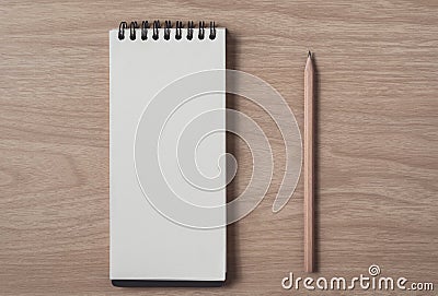 Notepad or notebook with pencil on brown wood table.using for education, business background Stock Photo