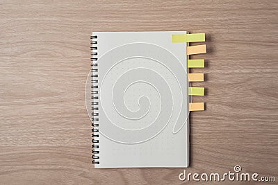 Notepad or notebook with sticky notes on brown wood table.using for education, business background Stock Photo