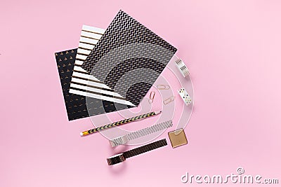 Notepad and notebooks with stationery. Golden, white, pink and black stationery back to school concept. Top horizontal view Stock Photo