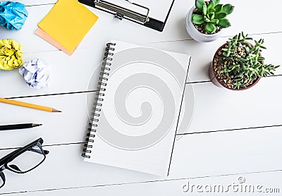 Notepad on office desk table with supplies and pot cactus Stock Photo