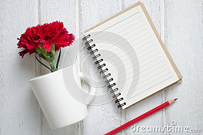 Notepad, pencil and Carnation flowers Stock Photo