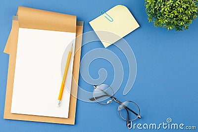 Notepad with pencil, glasses, plant and note sheet Stock Photo