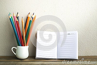 Notepad with pencil on wood board background.using wallpaper for education, business photo.Take note of the product for book with Stock Photo