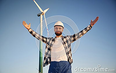 With notepad. Service engineer is on the field with windmills Stock Photo