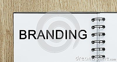 Notepad with text branding on wooden deskt. Business and finance concept Stock Photo