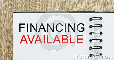 Notepad with text Financing Available on wooden deskt. Business and finance concept Stock Photo