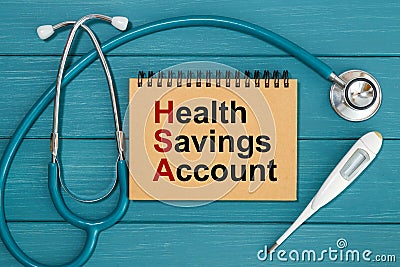 Notepad with text Health Savings Account HSA and stethoscope Stock Photo