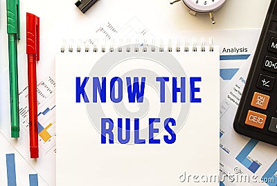 Notepad with the text KNOW THE RULES on a color financial chart. Business concept. Stock Photo