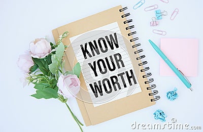 Notepad with text KNOW YOUR WORTH on deskt. Stock Photo