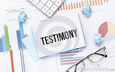 Notepad with text testimony on the business charts and pen,business Stock Photo