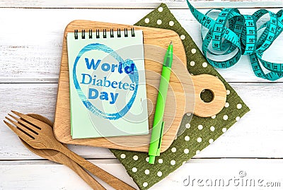 Notepad with World Diabetes Day text on the chopping board with Stock Photo