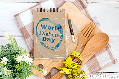 Notepad with World Diabetes Day text on the chopping board with Stock Photo