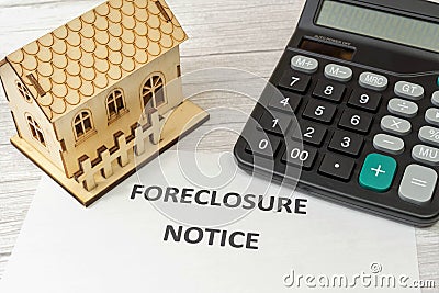 Notice of foreclosure of a house. Concept of eviction for non-payment of a mortgage to the bank. Rising interest rates. House and Stock Photo