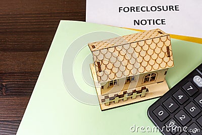Notice of foreclosure of a house. Concept of eviction for non-payment of a mortgage to the bank. Rising interest rates. House and Stock Photo
