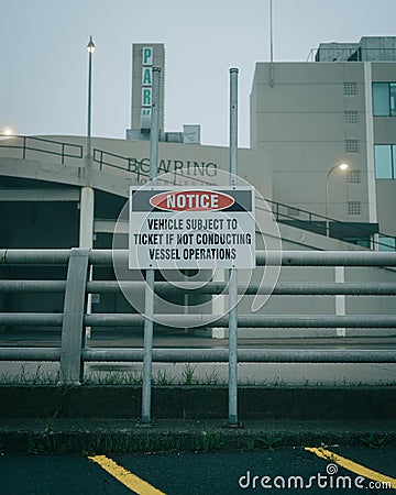 Notice sign on a foggy night at the harbor, St. Johns, Newfoundland and Labrador, Canada Editorial Stock Photo