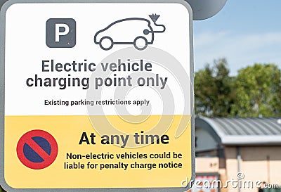 Notice warning of parking restrictions for non electric vehicles parking in an electric vehicle charging bay Stock Photo