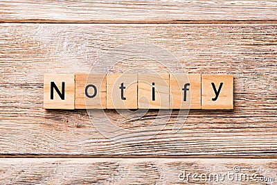 NOTIFY word written on wood block. NOTIFY text on wooden table for your desing, concept Stock Photo