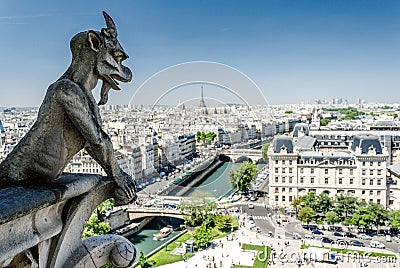 Notre-Dame de Paris. Famous Chimera demon overlooking the Eiffel Tower. Stock Photo