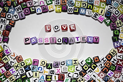 The noun and adjective LOVE PASSIONATELY written with colorful cubes isolated on a white background Stock Photo