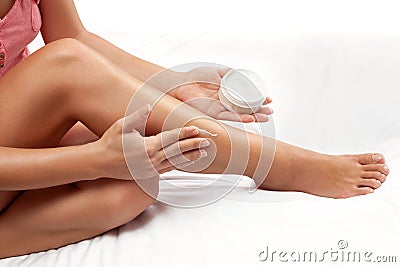 Nourished woman legs with hydrating cream on the skin Stock Photo