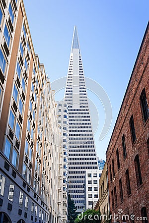 Nov 17, 2019 San Francisco / CA / USA - Transamerica Pyramid rising at the end of a narrow street with old fashioned office Editorial Stock Photo