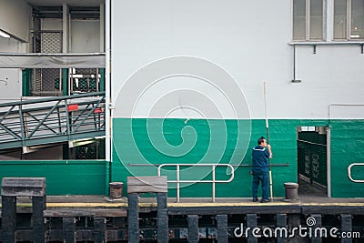 30 Nov 2019 - Star ferry pier, Hong Kong: Staff waiting the ferry parking to pier Editorial Stock Photo