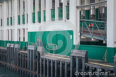 30 Nov 2019 - Star ferry pier, Hong Kong: Staff waiting the ferry parking to pier Editorial Stock Photo