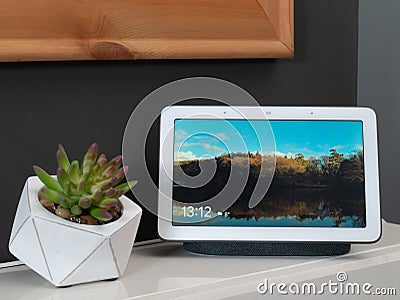 Nov 2019, UK - Google Nest Hub on mantlepiece with picture on show Editorial Stock Photo