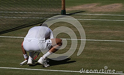 Novac Djokovic, Serbian player, wins Wimbledon for the fourth time. He crouches down in disbelief Editorial Stock Photo