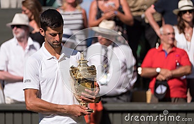 Novac Djokovic, Serbian player, wins Wimbledon for the fourth time. In the photo he holds the trophy on centre court. Editorial Stock Photo