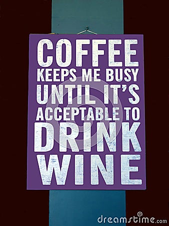 A novelty sign suggesting that Coffee will keep you busy until its time to drink wine Editorial Stock Photo