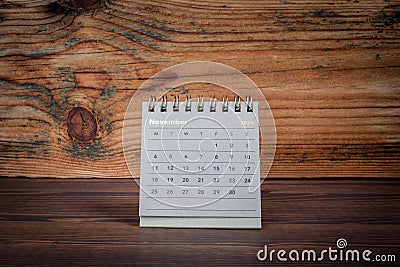 NOVEMBER 2024 cardboard desk calendar on a wooden texture background Stock Photo