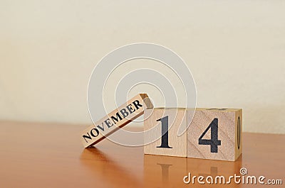 November 14, Date design with calendar cube on wooden table background. Editorial Stock Photo