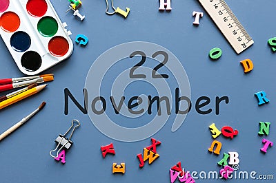 November 22nd. Day 22 of last autumn month, calendar on blue background with school supplies. Business theme Stock Photo