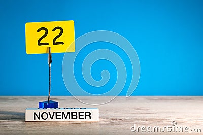 November 22nd. Day 22 of november month, calendar on workplace with blue background. Autumn time. Empty space for text Stock Photo