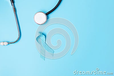 November Prostate Cancer Awareness, light Blue Ribbon with stethoscope for supporting people living and illness. Men Healthcare, Stock Photo