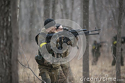 Active military exercises in the forest. Shootout army in the autumn forest. Training airsoft teams in Russia. Editorial Stock Photo