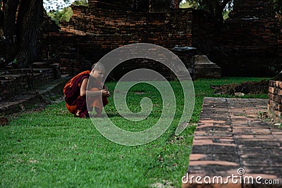 November 21th, 2018 - Ayutthaya THAILAND - Buddhist monk at ancient thai temple ruins Editorial Stock Photo