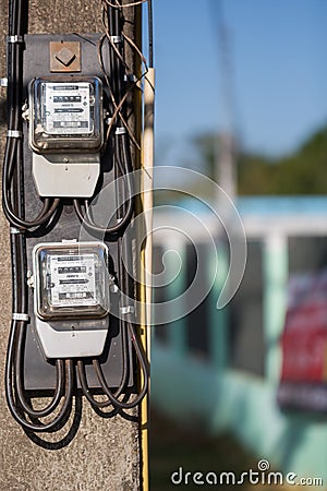 November 15th 2017 Udon Thani Thailand: electricity meter on electricity post in outdoor with blur nature background,The meter is Editorial Stock Photo
