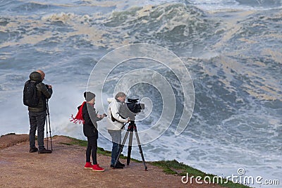 5 Novembro 19 - A videographer and a photographer working in `Praia Norte`, NazarÃ©,. Editorial Stock Photo