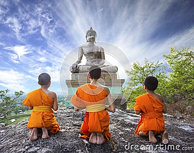 Novice Monk praying to the Buddha in Phrabuddhachay Temple Editorial Stock Photo