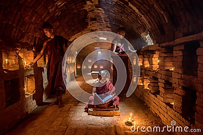 Novice monk reading book,in monastery Editorial Stock Photo