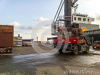 The port loader in the port drives around the site. Editorial Stock Photo