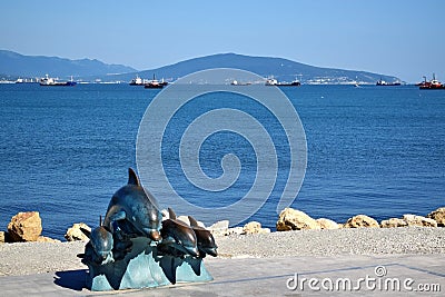 Novorossiysk, Russia - July 3, 2018: The bronze sculpture of dolphins at the embankment Editorial Stock Photo