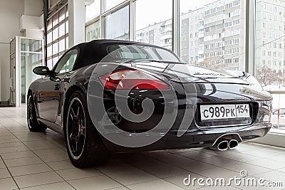 Rear view of the 2006 sport porsche boxster s sedan prepared for sale and exhibited in the showroom with a polished shiny black Editorial Stock Photo