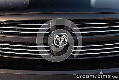 Black Dodge Ram with an engine of 5.7 liters front radiator grille view on the car parking with snow background Editorial Stock Photo